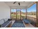 Comfortable screened-in porch with neutral furniture overlooking barn and horses at 2142 Henderson Tanyard Rd, Pittsboro, NC 27312