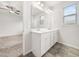 Ensuite bathroom featuring double sink vanity and a large framed mirror at 217 Mallard Loop Dr, Clayton, NC 27527