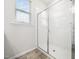Bathroom featuring walk-in shower with clear glass enclosure, subway tile and window at 217 Mallard Loop Dr, Clayton, NC 27527