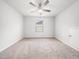 Carpeted bedroom features natural light from a window, a ceiling fan, and access panel on the wall at 217 Mallard Loop Dr, Clayton, NC 27527