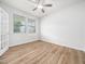 Bright bedroom featuring wood floors, neutral walls, and a modern ceiling fan at 217 Mallard Loop Dr, Clayton, NC 27527