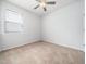 Bright bedroom featuring carpeted floors, a ceiling fan, and a window for natural light at 217 Mallard Loop Dr, Clayton, NC 27527
