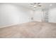 Carpeted room features natural light and a ceiling fan, with two access doors for storage at 217 Mallard Loop Dr, Clayton, NC 27527