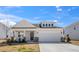 Charming home featuring stone accents, a covered porch, and a two-car garage at 217 Mallard Loop Dr, Clayton, NC 27527
