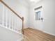 Bright foyer with wood floors and a staircase, leading to the upper level of the home at 217 Mallard Loop Dr, Clayton, NC 27527