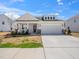 Inviting single-story home with a wide driveway and a covered front porch entrance at 217 Mallard Loop Dr, Clayton, NC 27527