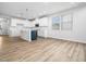 Open concept kitchen featuring an eat-in island, stainless steel sink and white cabinets at 217 Mallard Loop Dr, Clayton, NC 27527
