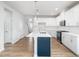 Bright kitchen features an island, stainless steel appliances, white cabinetry and tile backsplash at 217 Mallard Loop Dr, Clayton, NC 27527