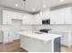 Spacious kitchen with white cabinets, stainless steel appliances, and a center island at 217 Mallard Loop Dr, Clayton, NC 27527
