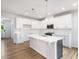 Bright kitchen features white cabinetry, stainless appliances, and a large center island at 217 Mallard Loop Dr, Clayton, NC 27527