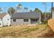 Spacious backyard, gray siding, dark roof, and a privacy fence line the perimeter at 220 Shawnee Dr, Louisburg, NC 27549