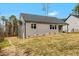 Spacious backyard with light gray siding, dark roof, and lush green surroundings at 220 Shawnee Dr, Louisburg, NC 27549