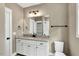 Well-lit bathroom featuring granite counters, white cabinets and subway tile shower at 220 Shawnee Dr, Louisburg, NC 27549