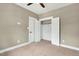 Carpeted bedroom featuring a ceiling fan, large closet with white doors and neutral walls at 220 Shawnee Dr, Louisburg, NC 27549