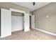 Carpeted bedroom featuring a closet with white doors and a ceiling fan at 220 Shawnee Dr, Louisburg, NC 27549