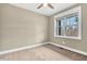 Bright bedroom featuring a large window, neutral walls, carpeted floors and a ceiling fan at 220 Shawnee Dr, Louisburg, NC 27549
