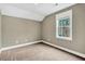 Neutral-toned bedroom featuring a window with bright natural light, perfect for a guest room at 220 Shawnee Dr, Louisburg, NC 27549
