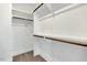 Bright walk-in closet with shelving, wood rods, and carpeted floors at 220 Shawnee Dr, Louisburg, NC 27549