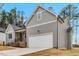 Attached garage with light gray siding and dark roof, complementing the home's exterior at 220 Shawnee Dr, Louisburg, NC 27549