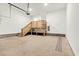 Spacious garage featuring a wooden platform with staircase, and neutral colored concrete flooring at 220 Shawnee Dr, Louisburg, NC 27549