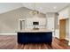 Modern kitchen boasts a large island with a stone countertop, contrasting cabinets and an open floor plan at 220 Shawnee Dr, Louisburg, NC 27549