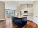 Open kitchen with an island, modern lighting, and stainless steel appliances at 220 Shawnee Dr, Louisburg, NC 27549