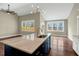 Kitchen with a view of living room, island with sink, modern lighting, and hardwood floors at 220 Shawnee Dr, Louisburg, NC 27549