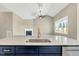 Bright kitchen island with sink, modern lighting, and an open view to the living room at 220 Shawnee Dr, Louisburg, NC 27549