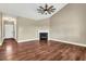 Cozy living room featuring a fireplace, hardwood floors, and a ceiling fan at 220 Shawnee Dr, Louisburg, NC 27549