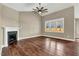 Spacious living room featuring a fireplace, hardwood floors, and a ceiling fan at 220 Shawnee Dr, Louisburg, NC 27549