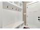 Bright mudroom with white bench seating, storage and coat hooks near entry door at 220 Shawnee Dr, Louisburg, NC 27549