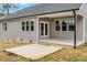 Covered patio area with light gray siding, white trim, and a concrete slab at 220 Shawnee Dr, Louisburg, NC 27549