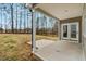 A covered patio with double doors offers seamless indoor-outdoor living and backyard view at 220 Shawnee Dr, Louisburg, NC 27549