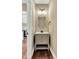 Powder room featuring a vanity with gray cabinets and granite counters at 220 Shawnee Dr, Louisburg, NC 27549