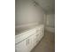 A spacious bathroom boasts a double sink vanity with white cabinets and a shower-tub at 226 Rolling Pasture Way, Sanford, NC 27332