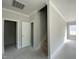 Hallway featuring a staircase, neutral paint, and access to various rooms, enhancing the home's flow at 226 Rolling Pasture Way, Sanford, NC 27332