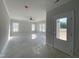 Bright and spacious living room with large windows, ceiling fan, and a door leading to the backyard at 226 Rolling Pasture Way, Sanford, NC 27332