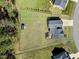 Aerial view of a home with a spacious, flat, fenced backyard and a storage shed at 236 Star Valley Dr, Angier, NC 27501