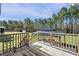 Wooden backyard deck with stairs leading to yard and a covered gazebo with table and chairs at 236 Star Valley Dr, Angier, NC 27501