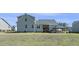 Wide shot of back of house, screened in porch, deck, and large green backyard at 236 Star Valley Dr, Angier, NC 27501