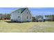Wide shot of back of house, screened in porch, deck, and large green backyard at 236 Star Valley Dr, Angier, NC 27501