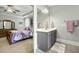 Bathroom with marble countertops, tiled floor, and view to the bedroom at 236 Star Valley Dr, Angier, NC 27501