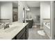 Main bathroom with marble countertops, tiled floor, soaking tub, and walk-in shower at 236 Star Valley Dr, Angier, NC 27501
