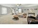 Spacious bonus room with multiple seating areas, neutral walls, and natural light at 236 Star Valley Dr, Angier, NC 27501