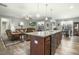 Open-concept kitchen with a large island, granite countertops, and seamless access to the living area at 236 Star Valley Dr, Angier, NC 27501