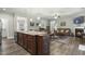 Open concept layout with kitchen island flowing into the living area with fireplace at 236 Star Valley Dr, Angier, NC 27501