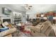 Cozy living room featuring a fireplace, plush seating, and seamless flow to the kitchen at 236 Star Valley Dr, Angier, NC 27501