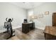 Well-lit home office with exercise bike, desk, chair, and natural light from a window at 236 Star Valley Dr, Angier, NC 27501