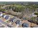 An aerial perspective of properties with green spaces, tree lines, manicured lawns, and community amenities at 239 Hopper Cir, Clayton, NC 27520