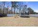 Large, grassy backyard complete with a trampoline and various play structures for recreation at 239 Hopper Cir, Clayton, NC 27520